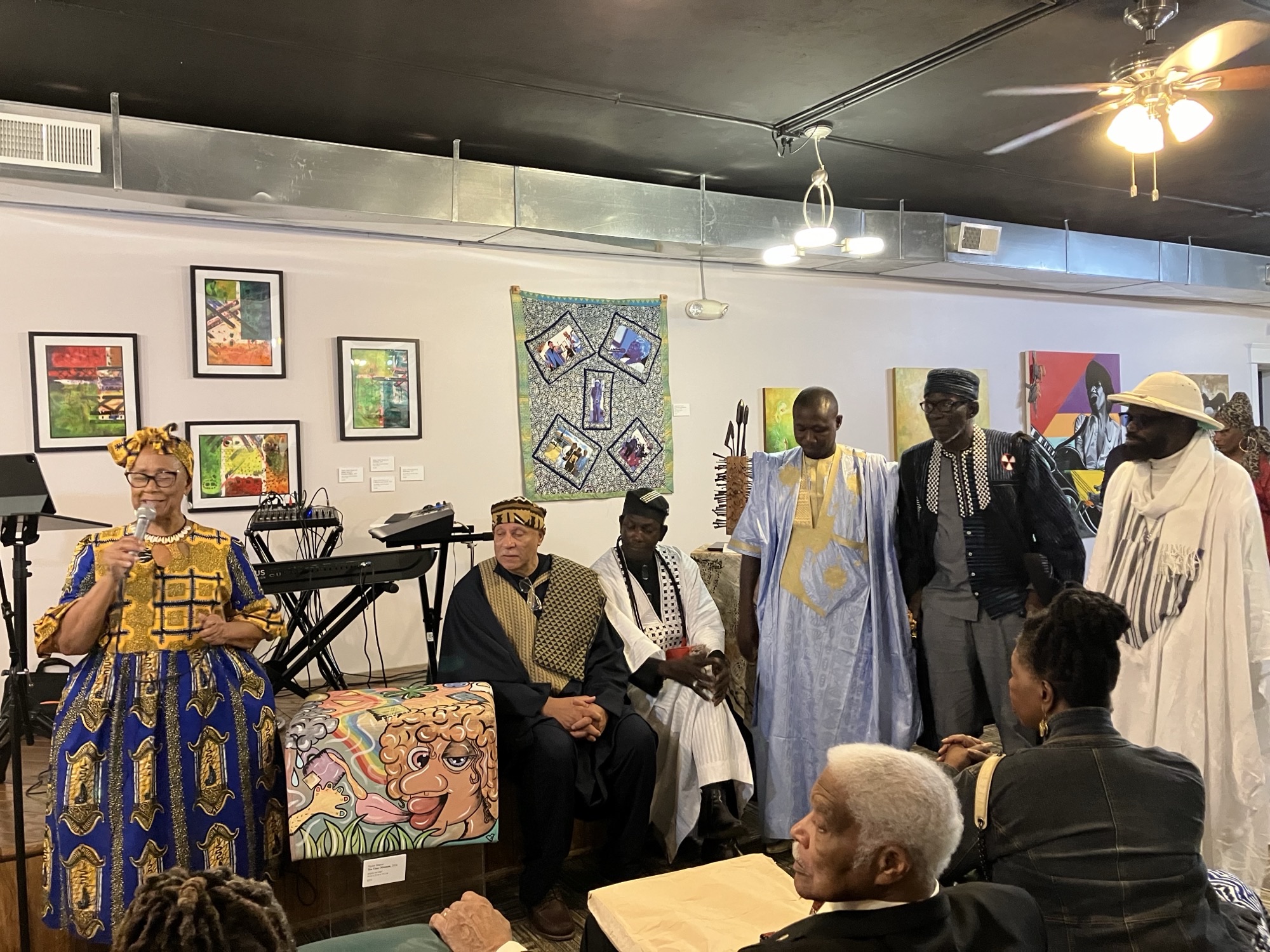 A group of people stand in a room decorate with art