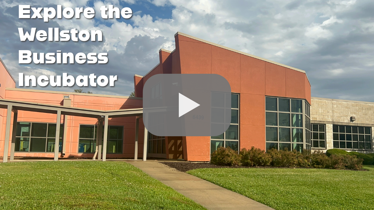 Picture of an orange building with the words explore the wellston business incubator