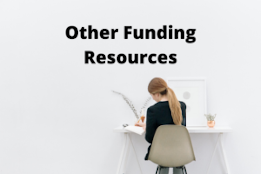 Woman working at a desk that says Other Funding Resources