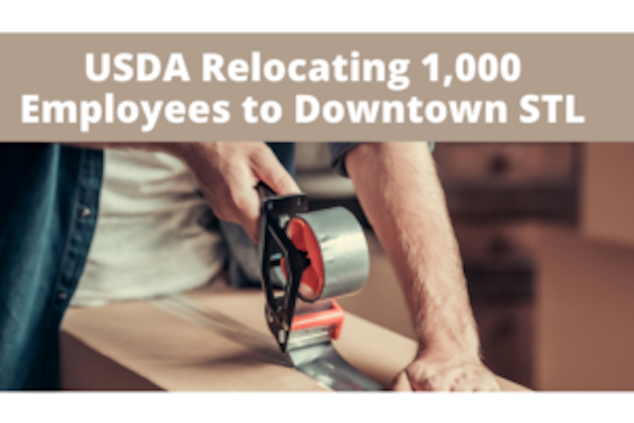 Image of a man taping a box that says USDA relocating 1,000 employees to Downtown St. Louis.