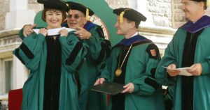 Crosslin’s hooding ceremony at the 2006 Washington University graduation ceremony where she is awarded an honorary doctorate in humanities. Chancellor Mark Wrighton (center) and Trustee Stephen Brauer look on. 