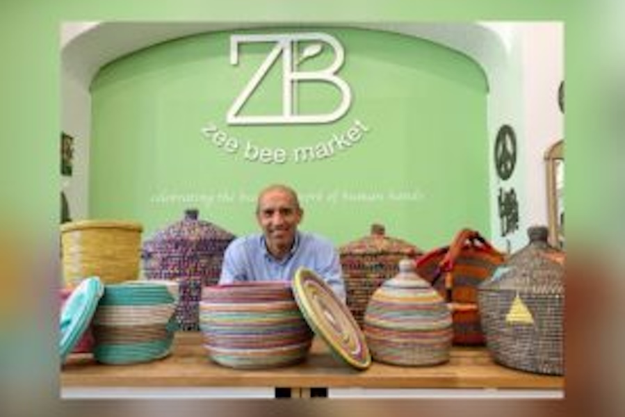 Image of a man surrounded by baskets with the Zee Bee logo