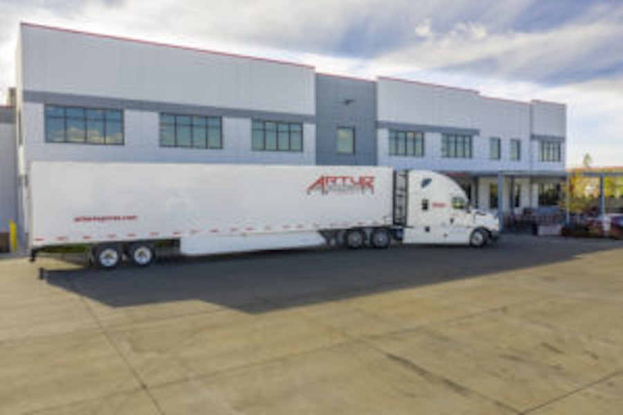 Image of a tractor trailer parked in front of a building