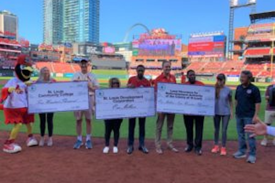 Photo of people holding checks at a Cardinal Game