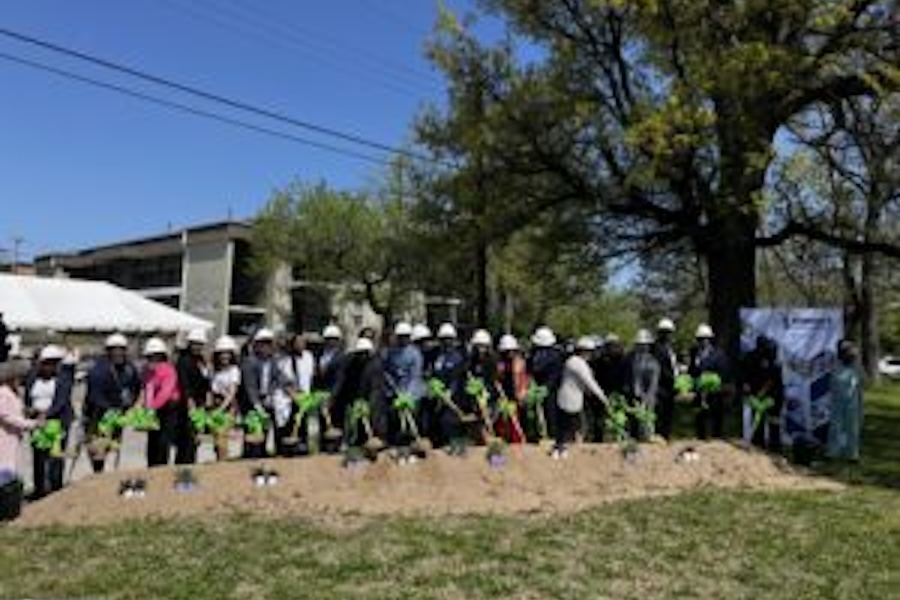 A group of people hold shovels in a ceremonial groundbreaking