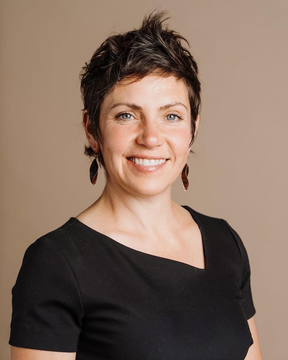 a woman poses with a smile