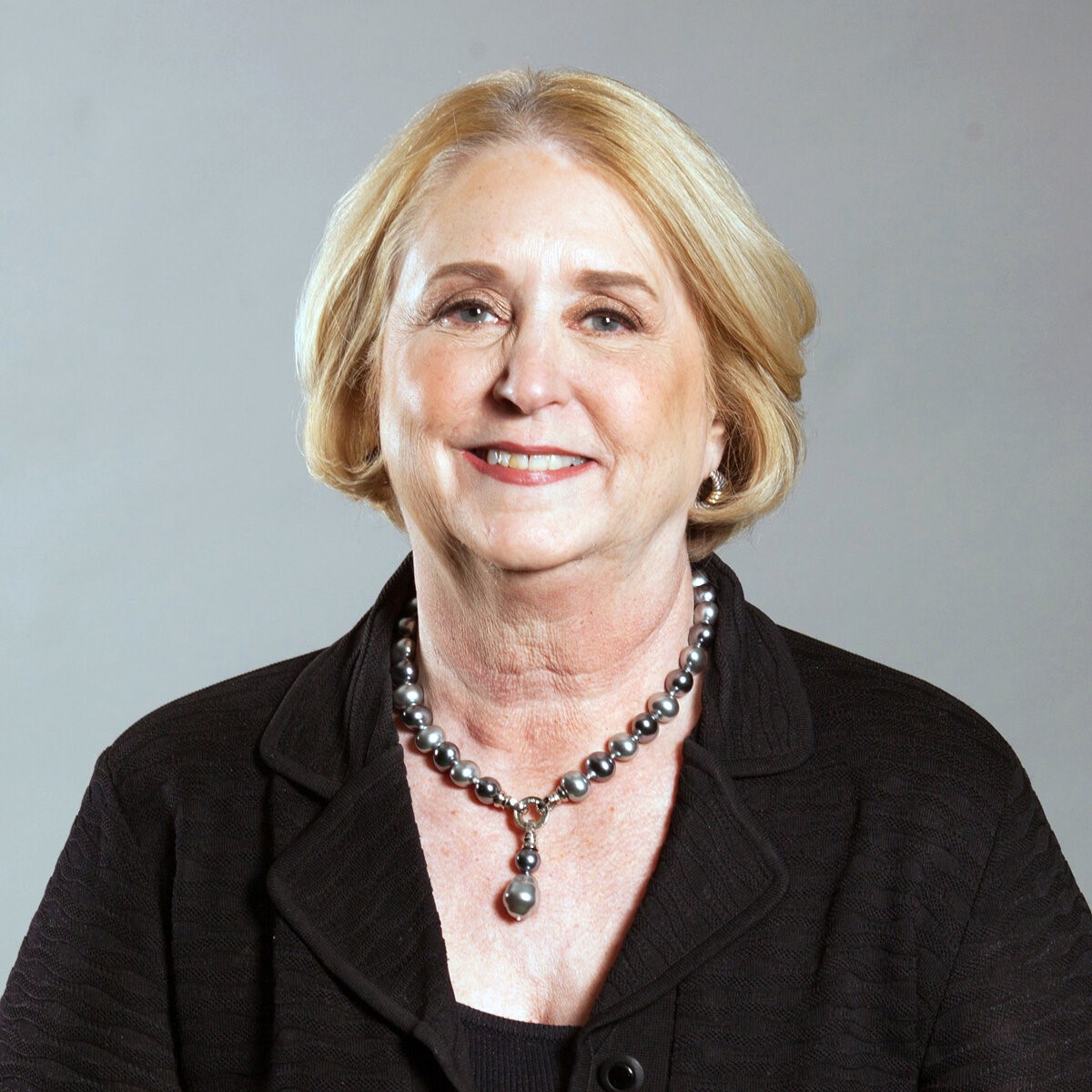 Headshot of a white woman dressed in professional attire