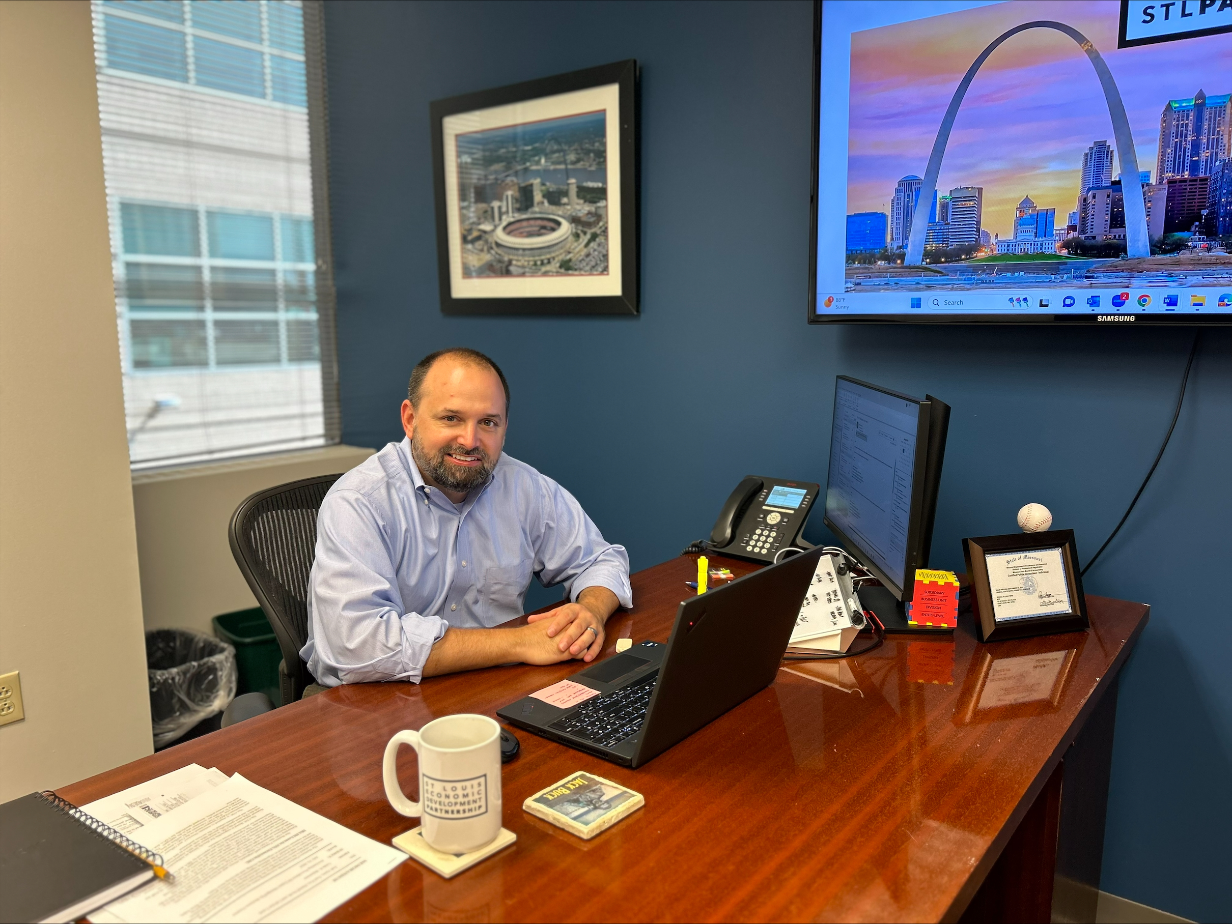 A man sits behind a desk