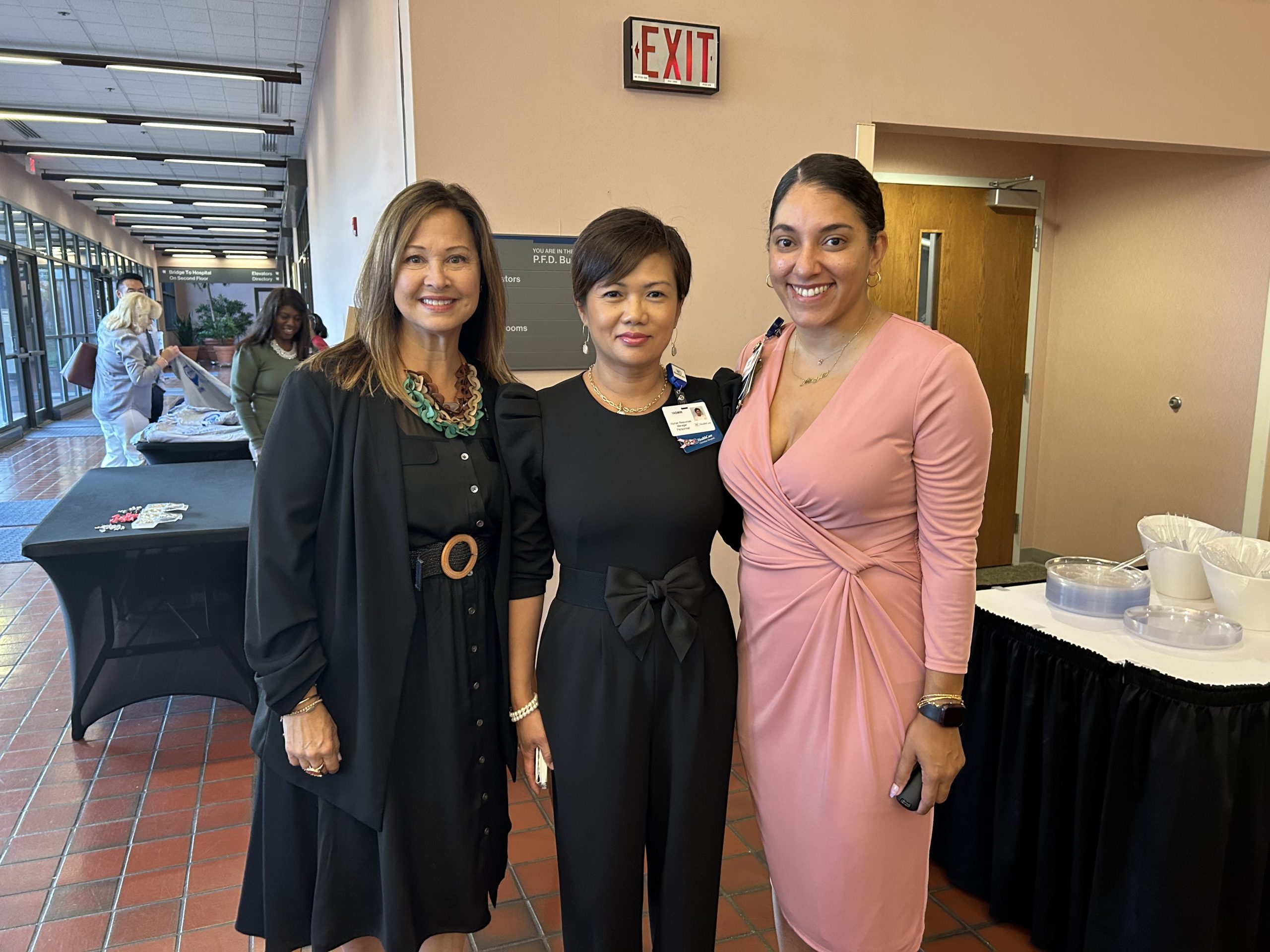 3 women stand posed for a picture