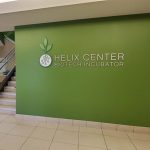 Image of a green wall with the text Helix Center