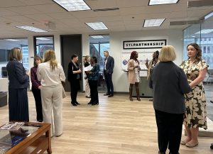 people stand in an office building talking in groups
