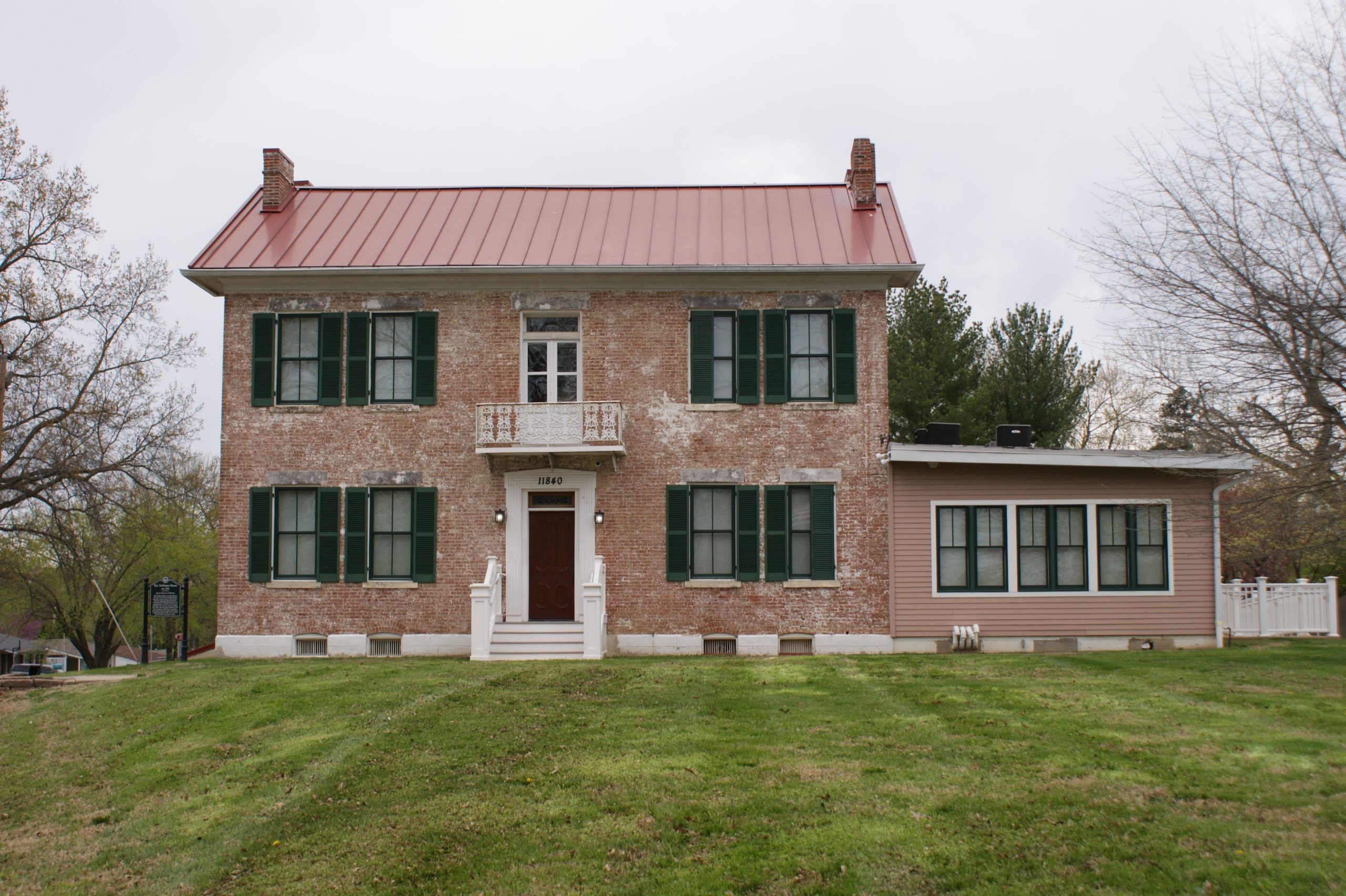 image of a red brick house with a red roof