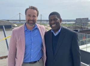 Two men stand on a roof