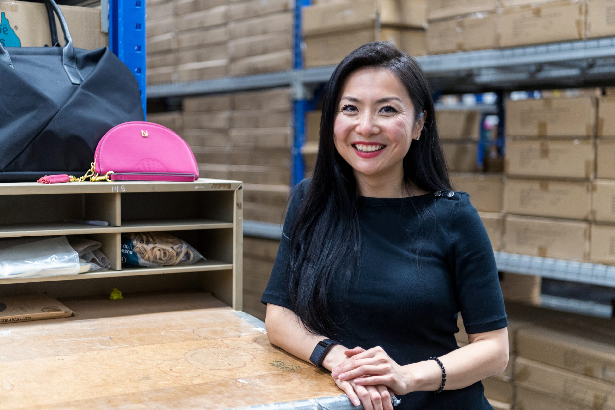 woman smiles in a warehouse