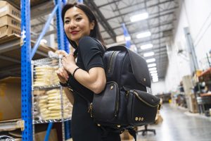 woman wears a backpack in a warehouse