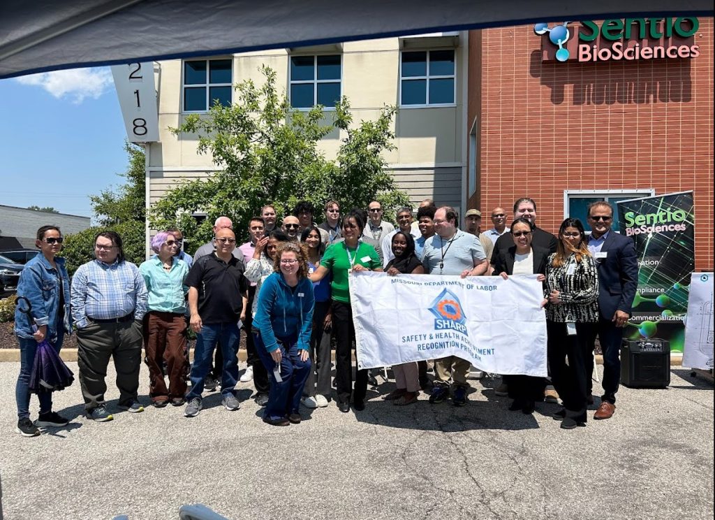 group photo of people outside, some holding banners