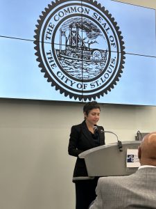 A woman speaks at a podium