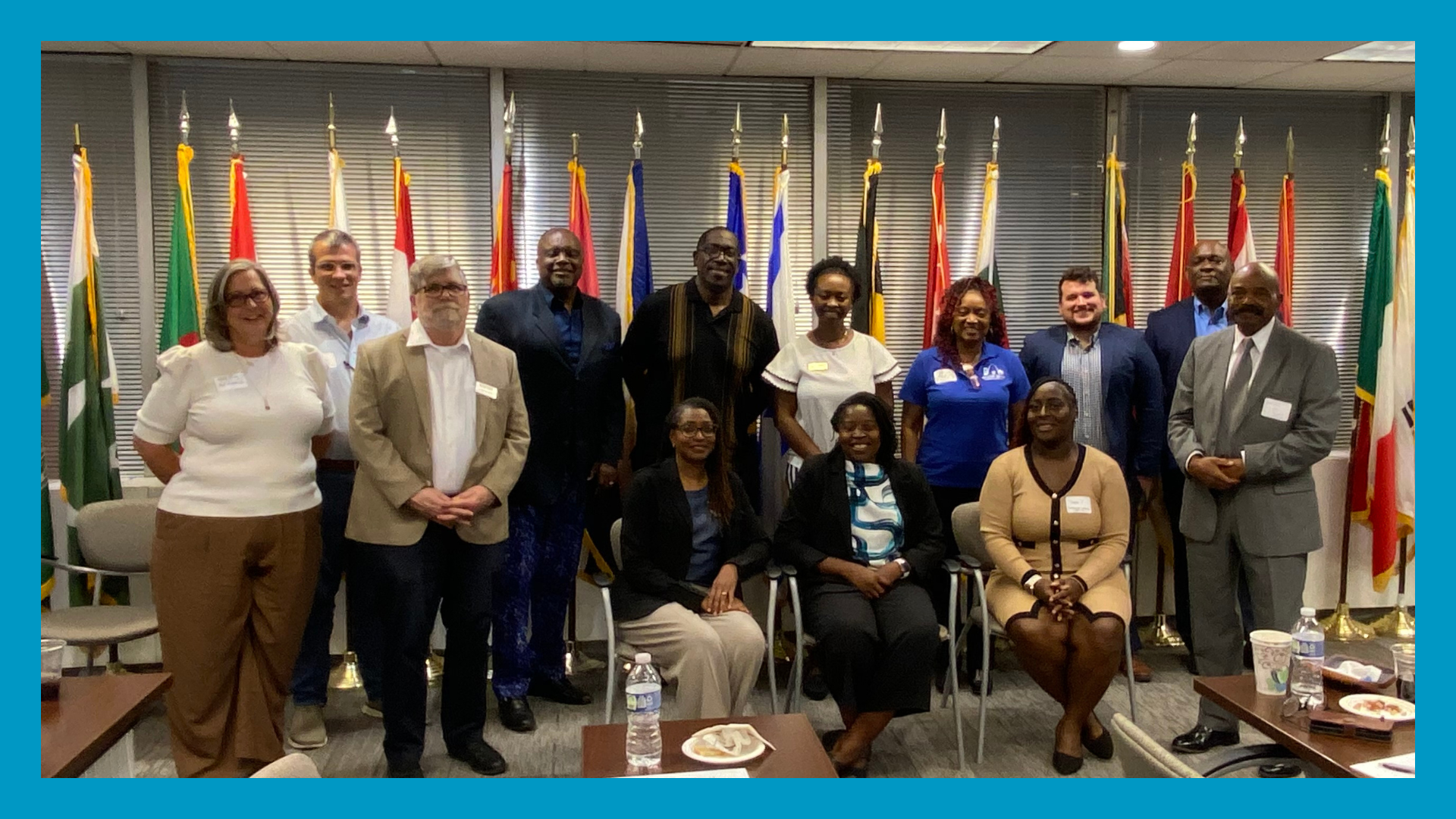 a group of people pose for a photo surrounded by a blue border