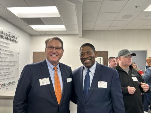 two men pose for photo