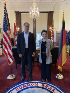 2 people standing inside looking at camera