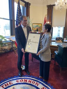 2 people holding proclamation looking at each other