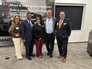 5 people stand posed for a photo