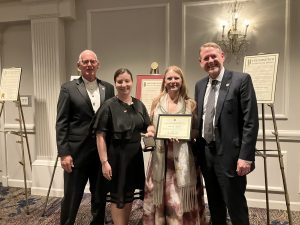 4 people posing indoors