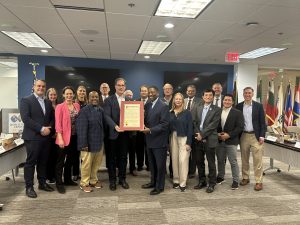 group of people standing holding a proclamation