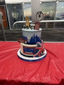 a ornately decorated london themed cake sits on a red table