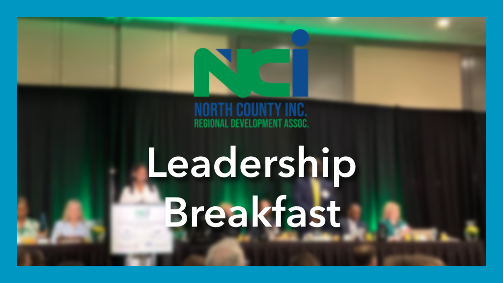 blurred photo of people sitting at table on stage, NCI logo over the pic as well as words saying "Leadership Breakfast" - blue border surrounds image