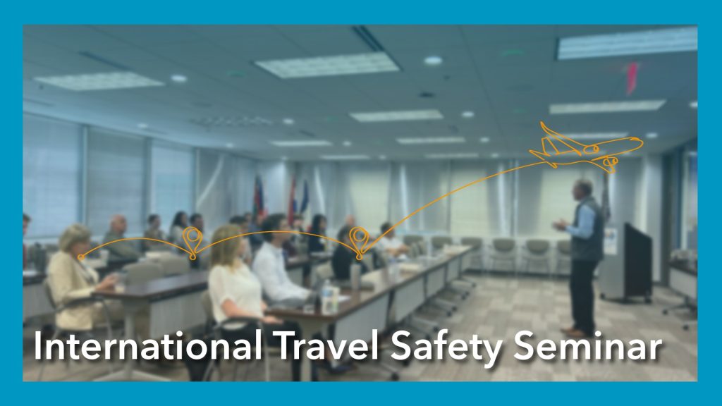ombre blue picture of people sitting for a seminar. blue border surrounds it. Text reads "international travel safety seminar"
