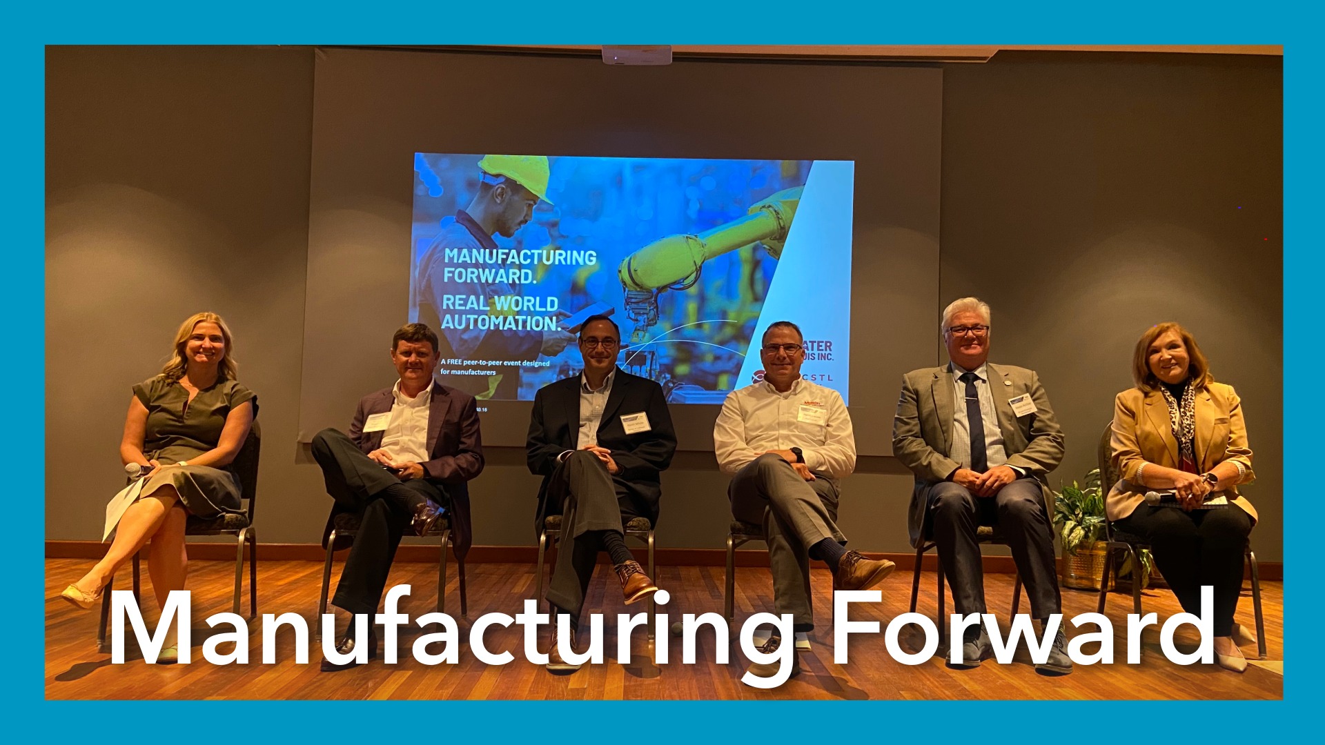 people sitting in a line on stage in chairs smiling. Text reads Manufacturing Forward at the bottom. Blue border surrounds image